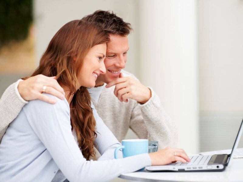 Couple is operating laptop