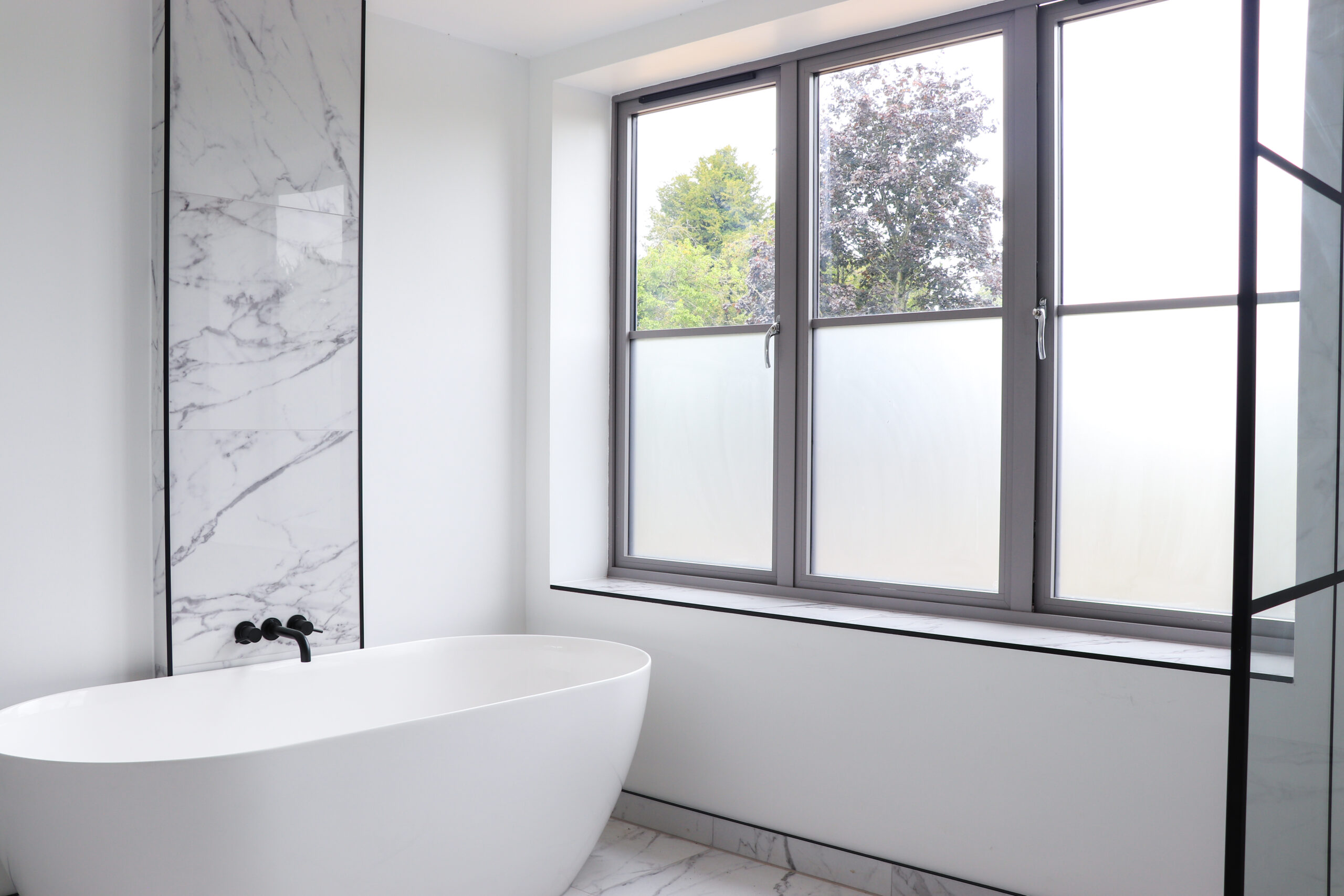 A modern bathroom with Cara Glass windows