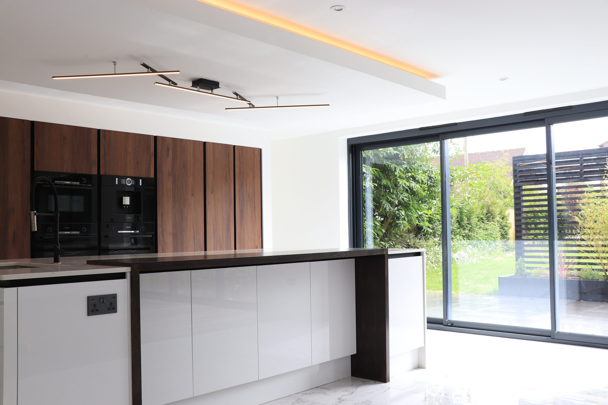 A modern kitchen with Cara Glass sliding doors